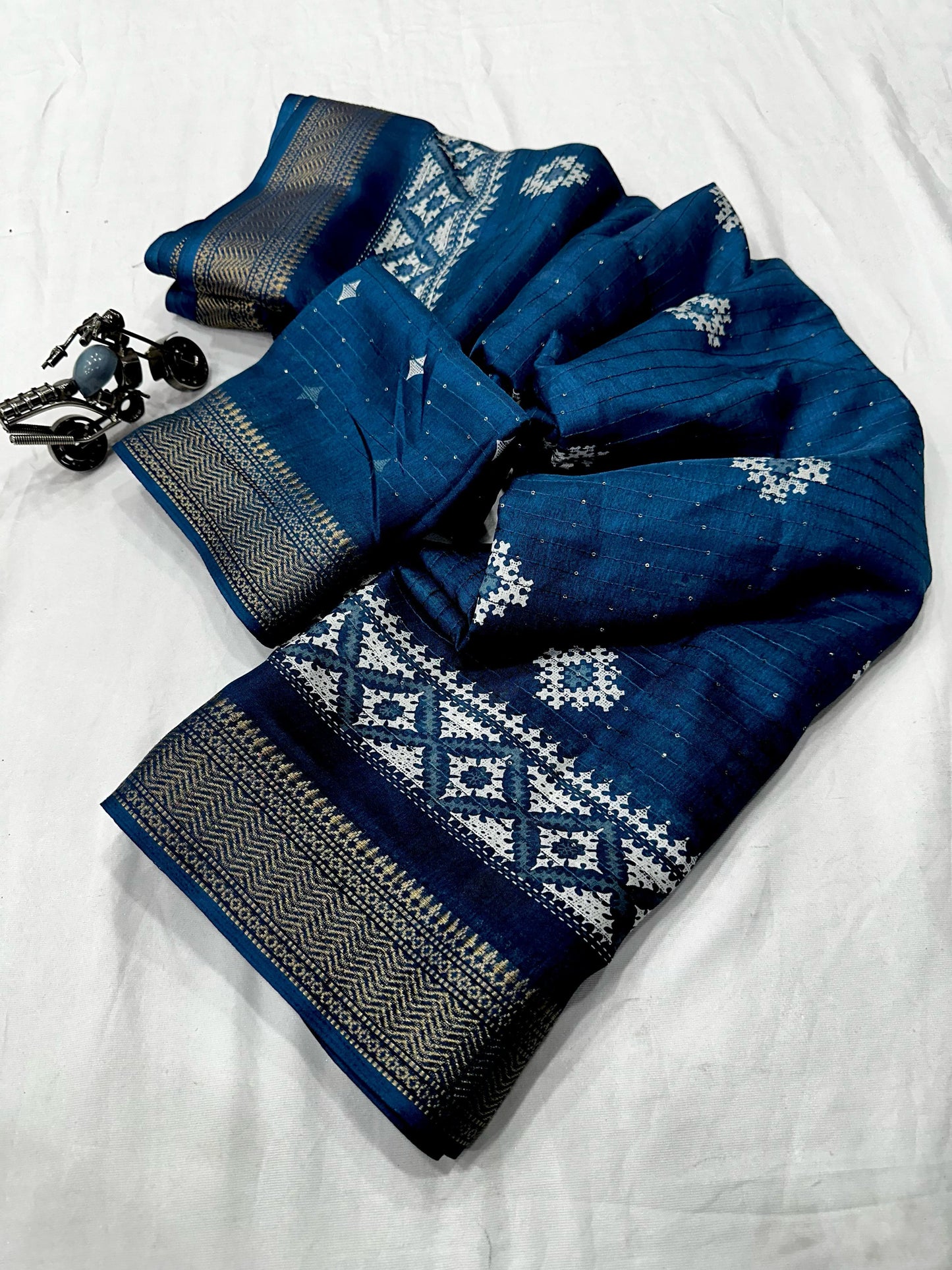 Beautiful Benny crape sikvach saree with all over doll design along with scallop maggam
